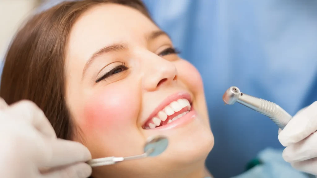 Woman smiling happily after dental treatment