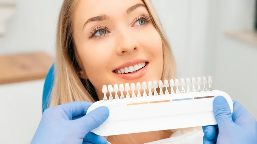 Dentist showcasing ceramic dental veneers for smile enhancement