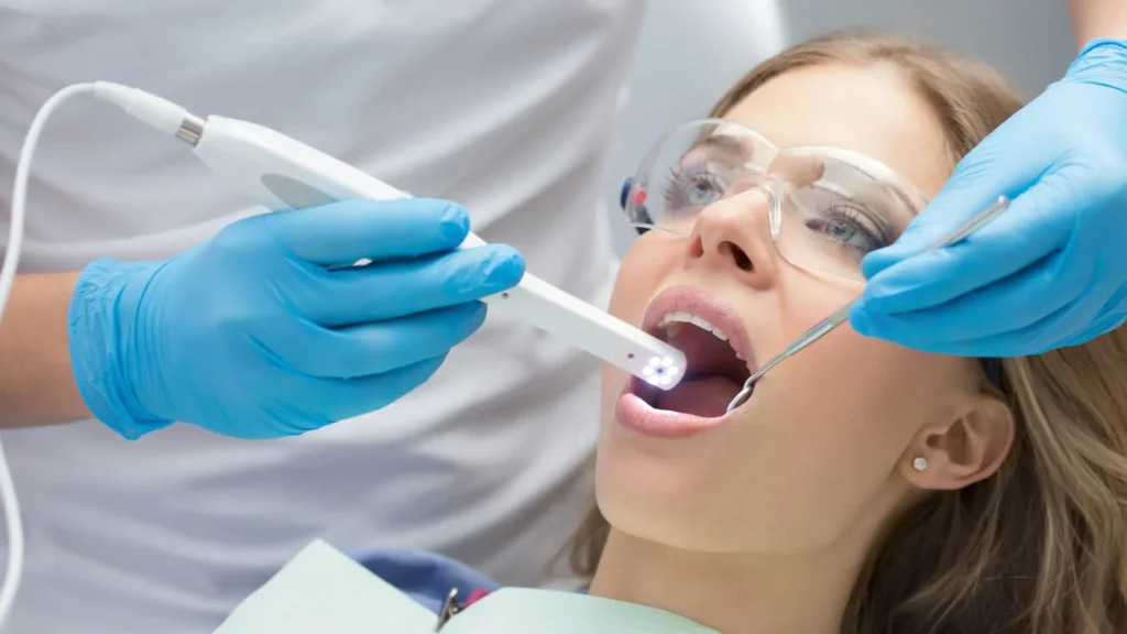 Dentist performing a dental check-up with instruments and lighting